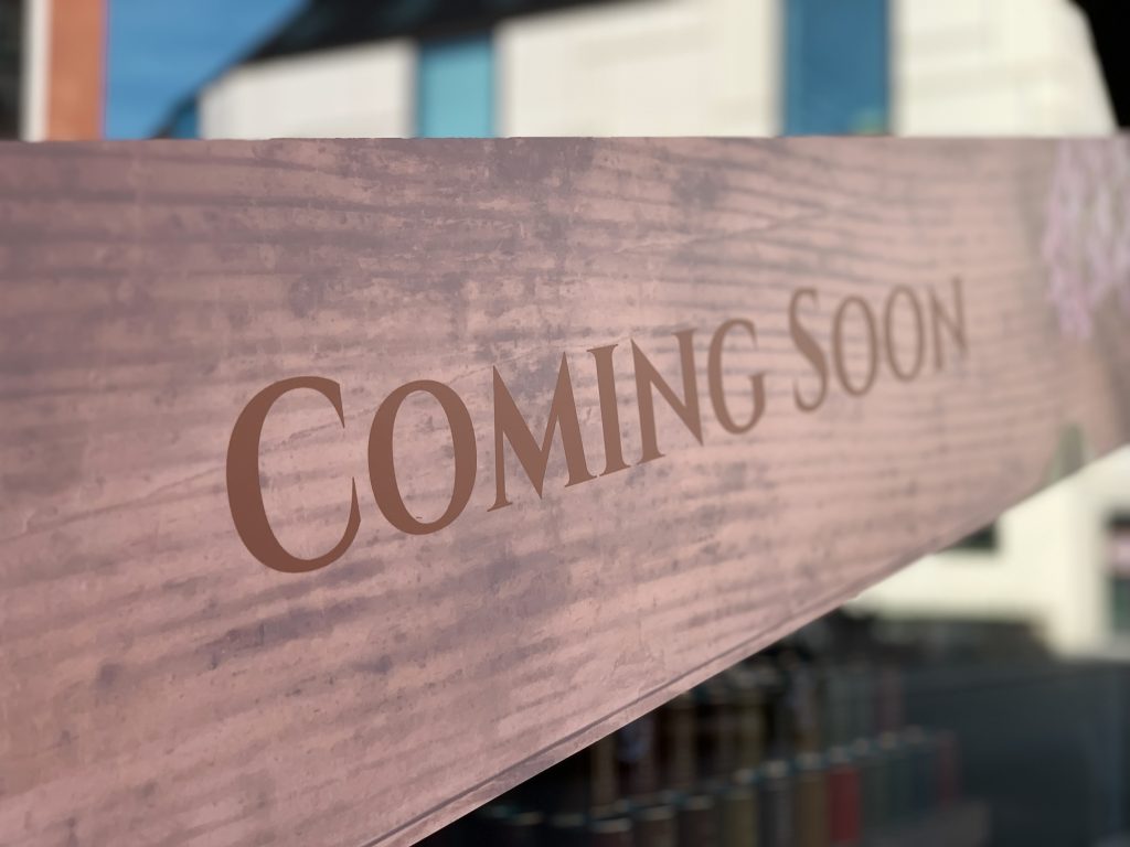 "Coming Soon" Written on Wooden Background